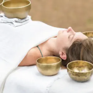 Woman receiving sound bath therapy.