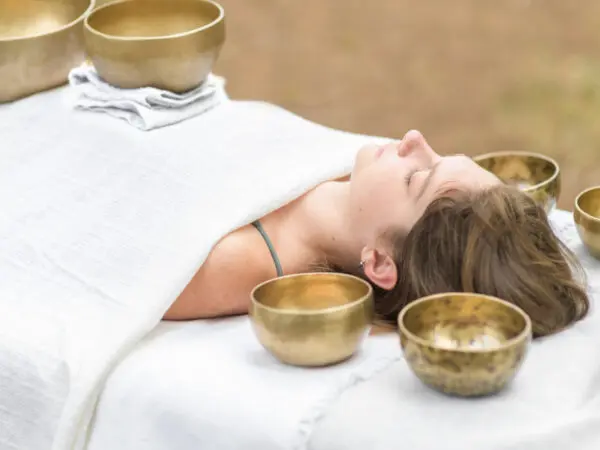 Woman receiving sound bath therapy.